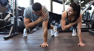 Image of man and woman doing Cardio Buckinghamshire to tone their arms. 